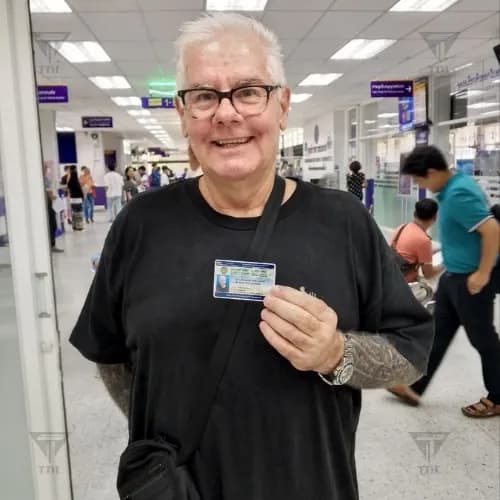 Older client proudly displaying new Thai driving license