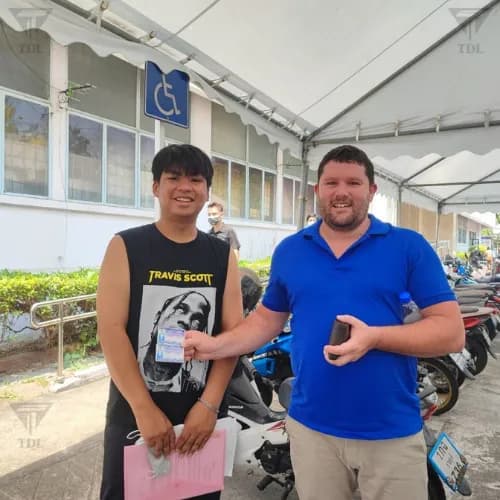TDL Service staff with client smiling outside DLT office