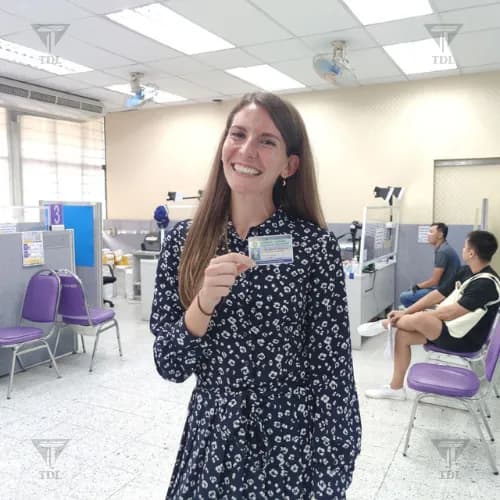 Happy woman showing her new Thai driving license